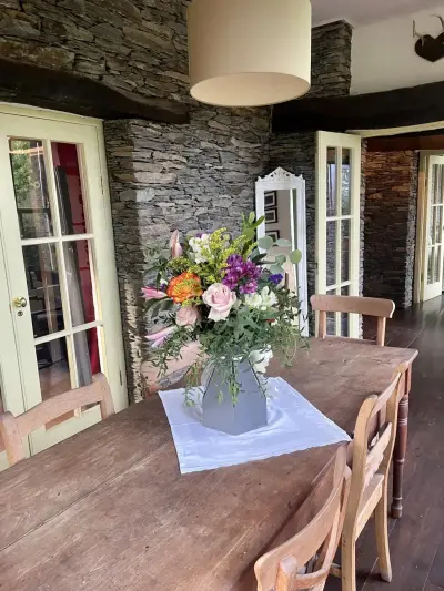 A tall table bouquet in a country dining room